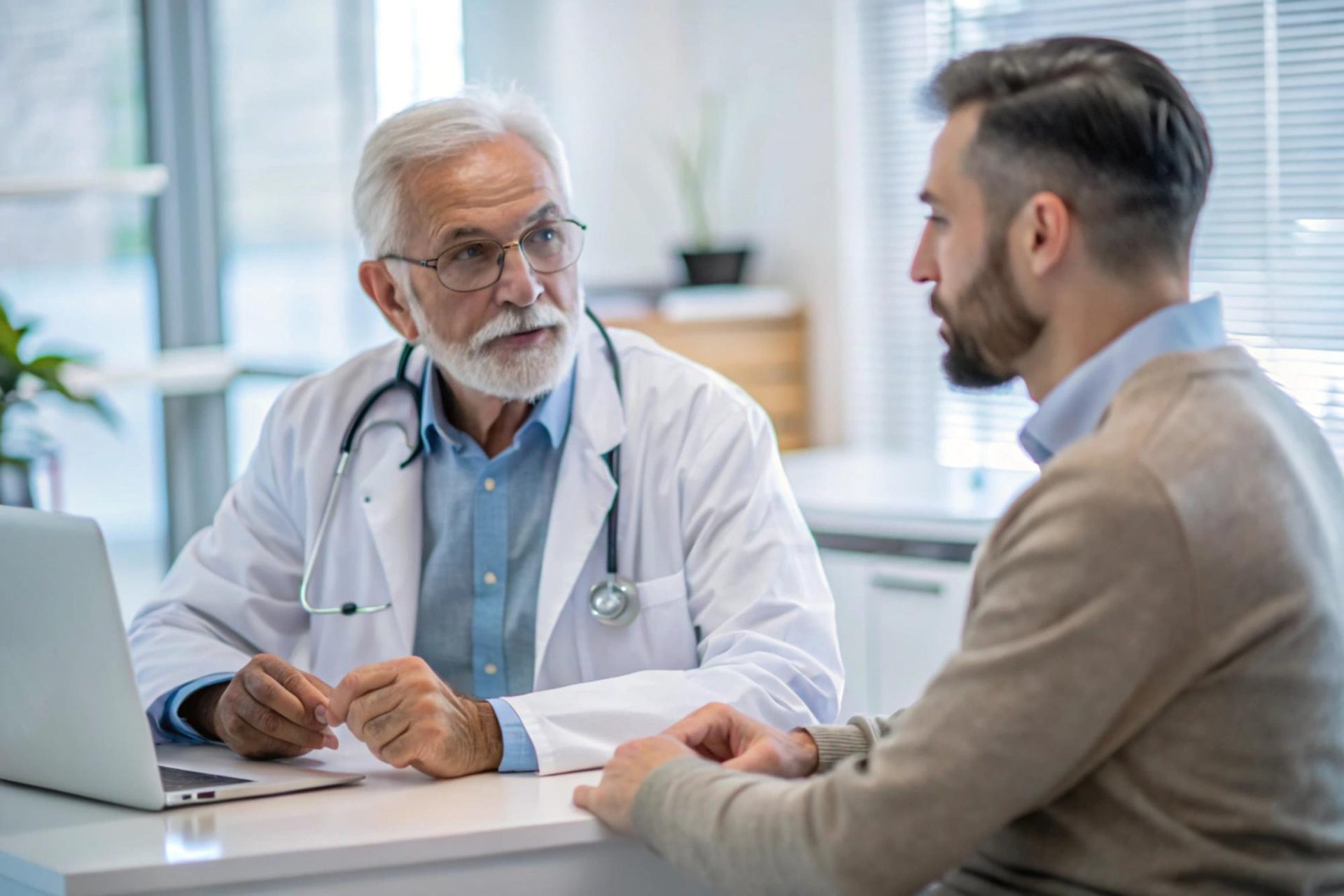 Erfahrener Hausarzt im Beratungsgespräch mit einem Patienten
